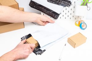 Person packs polymailer bubble packaging