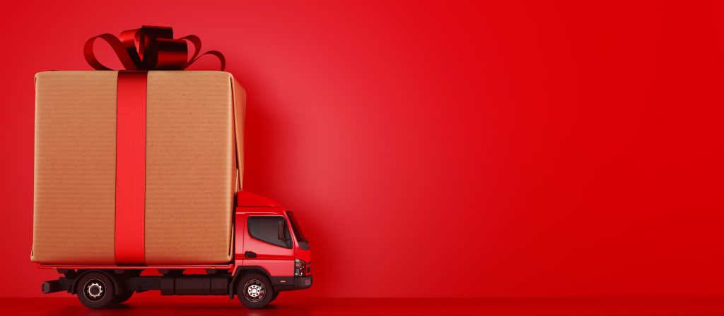Big holiday or Christmas gift package on a red truck ready to be delivered
